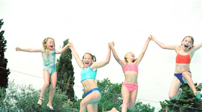Girls playing at the pool --- Image by © Royalty-Free/Corbis